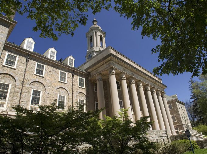Penn State Old Main building against blue sky